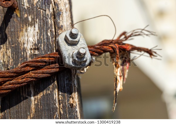 Close picture of a wire rope with a\
wire rope clamp of an old Bulgarian suspension\
footbridge