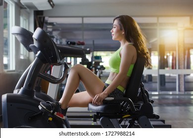 Close Up Picture  The Woman Is Exercise Legs On A Recumbent Bike In The Gym 