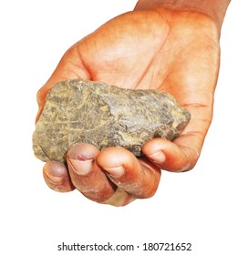 A Close Up Of Piece Of Coltan Ore In Congolese Hand Isolated On White.