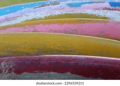 close up of a pile of colorful surfboards that are dull and dirty. suitable for background and texture themes.