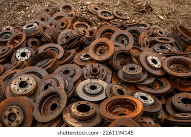 close up of pile of rusty car rotors at scrap yard  - Shutterstock ID 2261194145