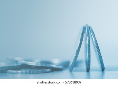 Close Up Of Pile Of Silver  Coins Over Soft Background In Blue Tone With Copy Space For Finance Business And Banking Concept