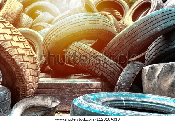 Close up to piles\
of old tire car texture pattern on background view. Vintage car \
wallpaper Sun light tone.