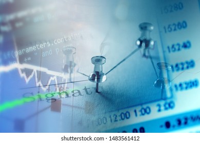 Close up of pin on graph data. Finance concept.