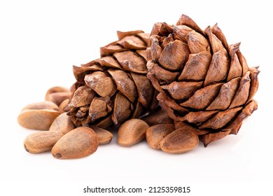 Close up pine nuts and pine cone isolated on white background.