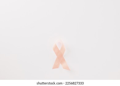 Close up pink awareness ribbon of International World Cancer Day campaign isolated on white background with copy space, concept of medical and health care support, 4 February - Shutterstock ID 2256827333