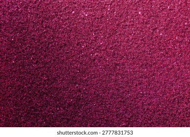 A close up of a pink background with a lot of glitter. The glitter is scattered all over the background, giving it a shiny and festive appearance
