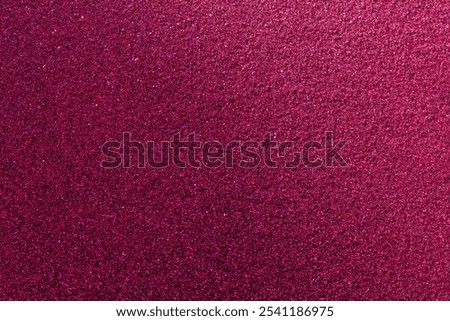 A close up of a pink background with a lot of small dots. The background is very bright and the dots are very small