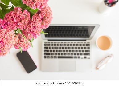 Close Up Of Pink And Orange Cockscomb Flowers From Above With Home Office Items Below, Including Laptop, Phone, Glasses And Cup (selective Focus)