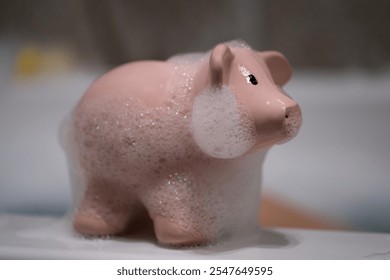 Close up of a pink pig toy covered in bubbles - Powered by Shutterstock