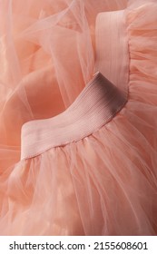 Close up of pink tulle skirt
				