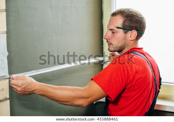 close up plasterer\
concrete worker at wall