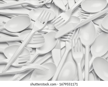 Close Up Of Plastic Cutlery Spoon, Fork, Knife On White Background