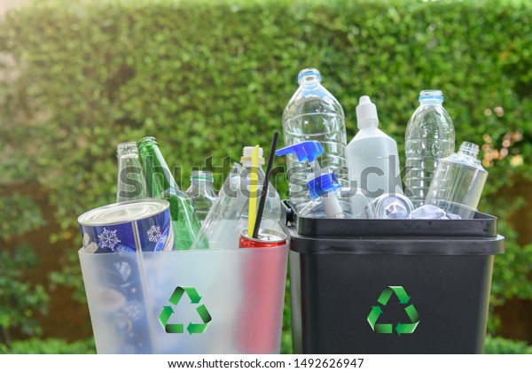 Close up plastic and  glass bottle in the bins for separating recycle materials from the garbages. Reducing waste by following the green concept. Recycling process.