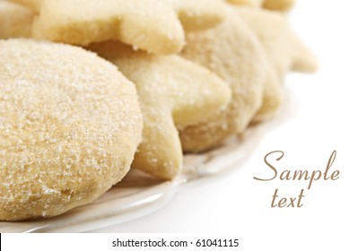 Close Up Of A Plate Of Sugar Coated Round And Star Shaped Cookies On A Plate