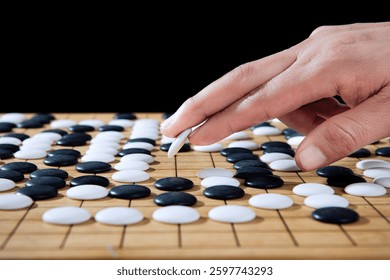 close up of player hand make a move in Go game(Weiqi),Traditional trategy board game