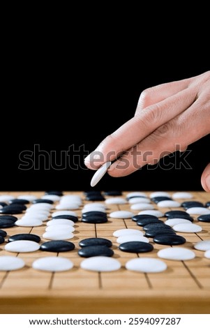 close up of player hand make a move in Go game(Weiqi),Traditional trategy board game