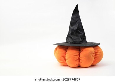 Close up of plush pumpkin with witch hat Haloween concept.
				Pumpkin plush toy with witch hat with white background. Pumpkin with witch hat with space for text.