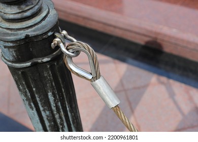 Close Up Pole With Metal Restraining Rope. Barrier, Enclosed VIP Area, Protected Entrance, Private Event,  Restrict Area Barricade Pole.