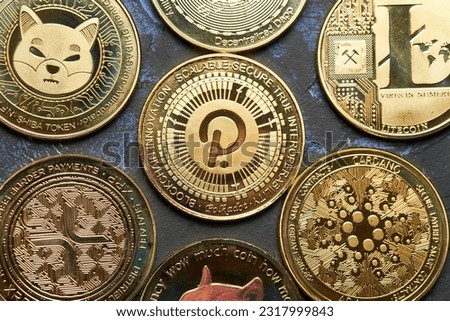 Close up of Polkadot cryptocurrency and Various cryptocurrencies with dark textured background and view from above
