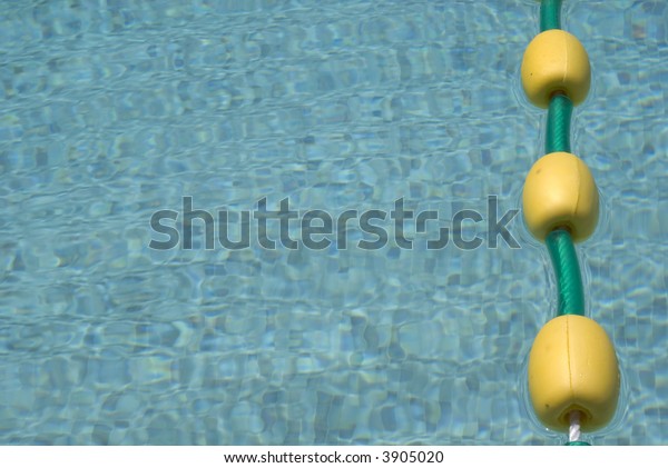 Close up of a\
pool with a line of yellow\
floats