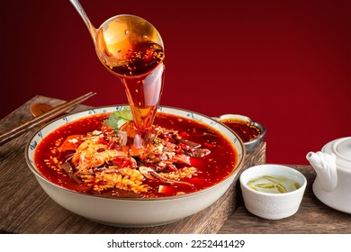 Close up of a popular Chinese Sichuan province cuisine Sliced Duck Blood in Chili Sauce oil with lunch meat, tripe and eel slices (Chinese: Mao xue wang)