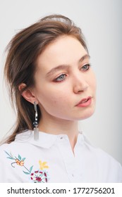 Close Up Portrait Of 20-25 Years Old Girl In A White Blouse. Beautiful Girl With A Tail Posing And Not Looking At The Camera