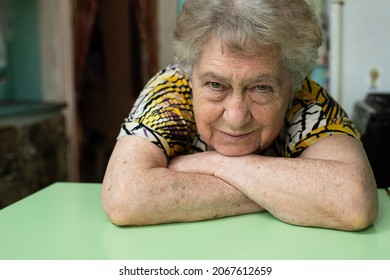 Close Up Portrait Of 80 Year Old Woman At Home In The Kitchen.