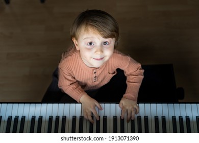 Close Up Portrait Of Adorable Little Toddler Boy. Smiling Child Playing Piano At Home. Kid Learning  Play Music. Early Development.