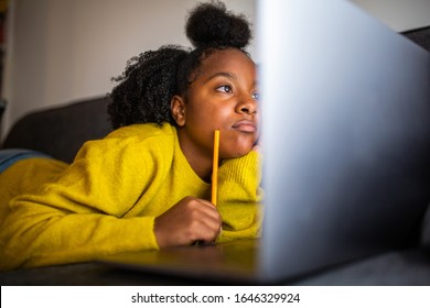 Close up portrait african american girl student looking at laptop computer screen