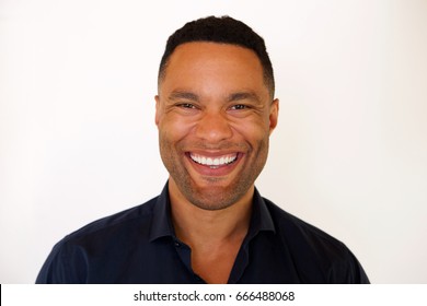 Close Up Portrait Of African American Young Man Smiling Against White Background