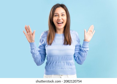 Close Up Portrait Of Amazed Woman Gesturing Shock, Extremely Happy, With Wide Open Eyes, Shouts Isolated On Blue Background. 
