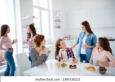 Close Up Portrait Amazing Beautiful She Her Ladies Family Meeting Sister Cousins Nephews Stand Sit Round Big White Table In Bright Kitchen Hold Cups Girls Day Night Holiday Indoors