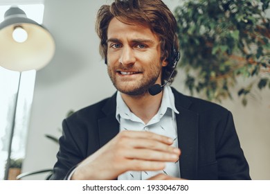 Close up portrait of an angry businessman with headset having stressful online conversation