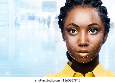 Close Up Portrait Of Attractive African Woman With Facial Recognition Technology. Grid With Reference Areas Marked On Face. Young Girl Against Out Of Focus Airport Background.
