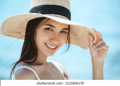 Close Up Portrait Of Attractive Asian Woman In Straw Hat Looking At Camera