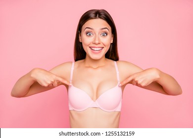 Close up portrait of attractive beautiful delighted gorgeous skinny her she girl showing nice proportions of decollete cleavage in push up bra isolated on pink background
