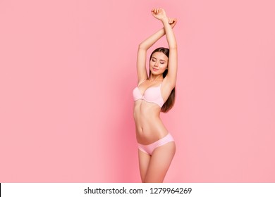 Close up portrait of attractive beautiful gorgeous gentle brunette her she girl standing with hands up satisfied with lotion balm soap scent wearing pale pink underwear isolated on pink background