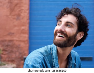 Close Up Portrait Of An Attractive Man With Beard Laughing 