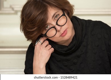 Close Up Portrait Of Attractive Stylish Charming Confident, Attentive Woman Wearing Glasses. Active Beautiful Middle-aged Businesswoman Looking Into Camera.