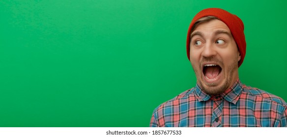 Close up portrait of attractive young model isolated on green background. Young man is surprised. 
Hipster - Powered by Shutterstock