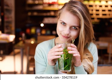 Close Up Portrait Of An Attractive Young Woman Drinking Mint Tea