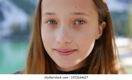 close up portrait authentic real emotion teen young girl blue eyes  natural in nature light confidence expression neutral face caucasian girl power