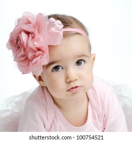 Close Up Portrait Of Baby Girl Wearing Head Band With Big Pink Flower