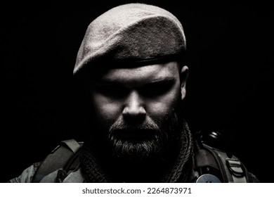 Close up portrait of bearded commando fighter, army special forces soldier, private military company mercenary wearing beret. Pride and tradition of military service, elite or special forces unit