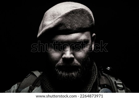 Close up portrait of bearded commando fighter, army special forces soldier, private military company mercenary wearing beret. Pride and tradition of military service, elite or special forces unit