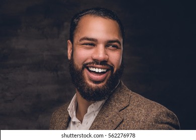 Close Up Portrait Of Bearded Smiling Black Man In A Wool Suit.