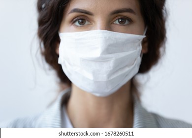 Close up portrait of beautiful 30s young millennial woman cover her face wearing facial medical blue mask, anti-coronavirus COVID-19 pandemic infectious disease outbreak protection, healthcare concept - Shutterstock ID 1678260511
