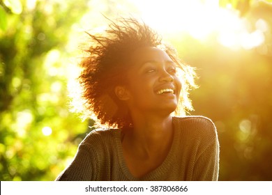 Close Up Portrait Of A Beautiful African American Woman Smiling With Sunset