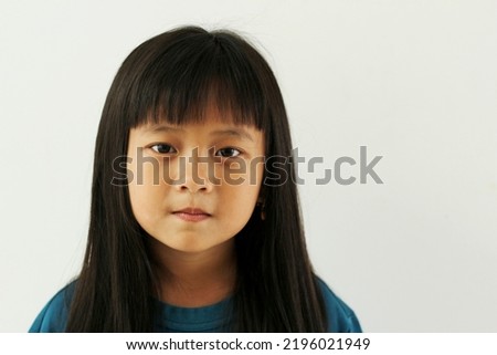 close up portrait of beautiful asian girl with bangs long straight hair looking at camera isolated on white background. copy space.